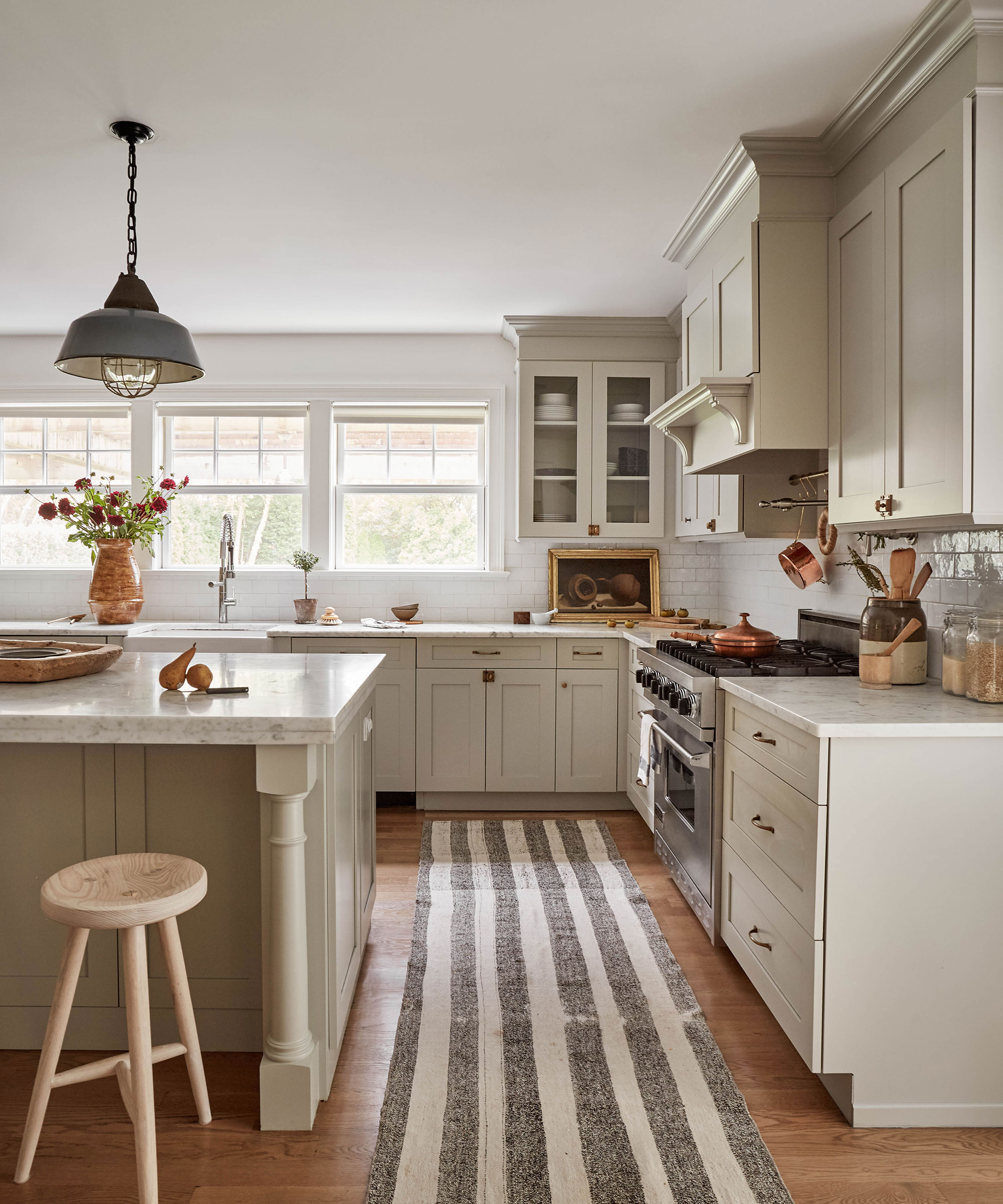 Fall kitchen with neutral cabinets and rug