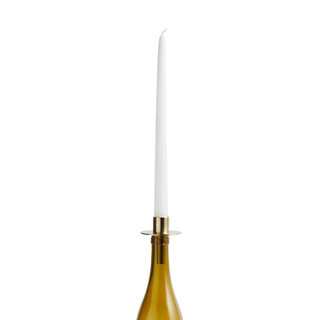 candle mounted in a wine bottle