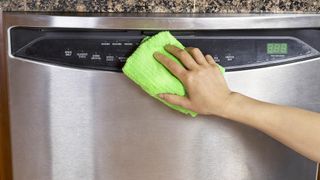 Wiping stainless steel appliance with cloth