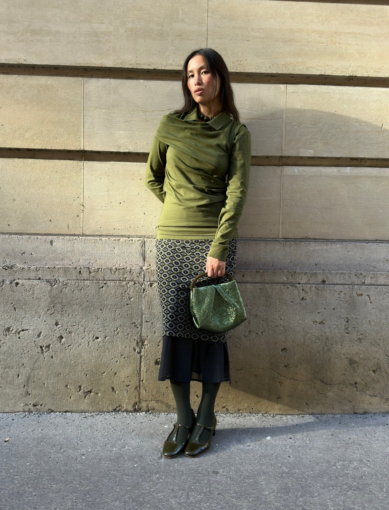 Fashion person Anne-Victorie Lefevre wears a coloured tights outfit. She wears dark green tights.