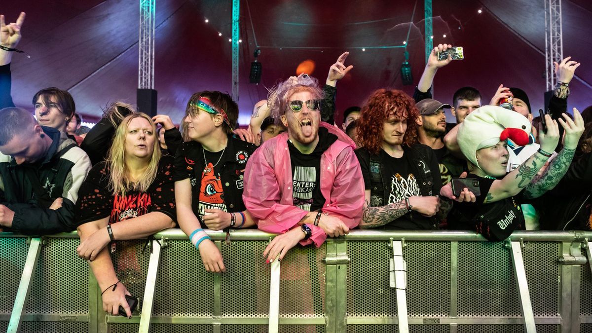 A crowd gathered at the railing at a festival