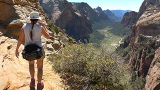 Woman hikes Zion National Park desert Angels Landing Trail Utah