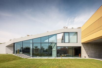 Exterior of the Baraka Seaside Residence with green lawns and large windows