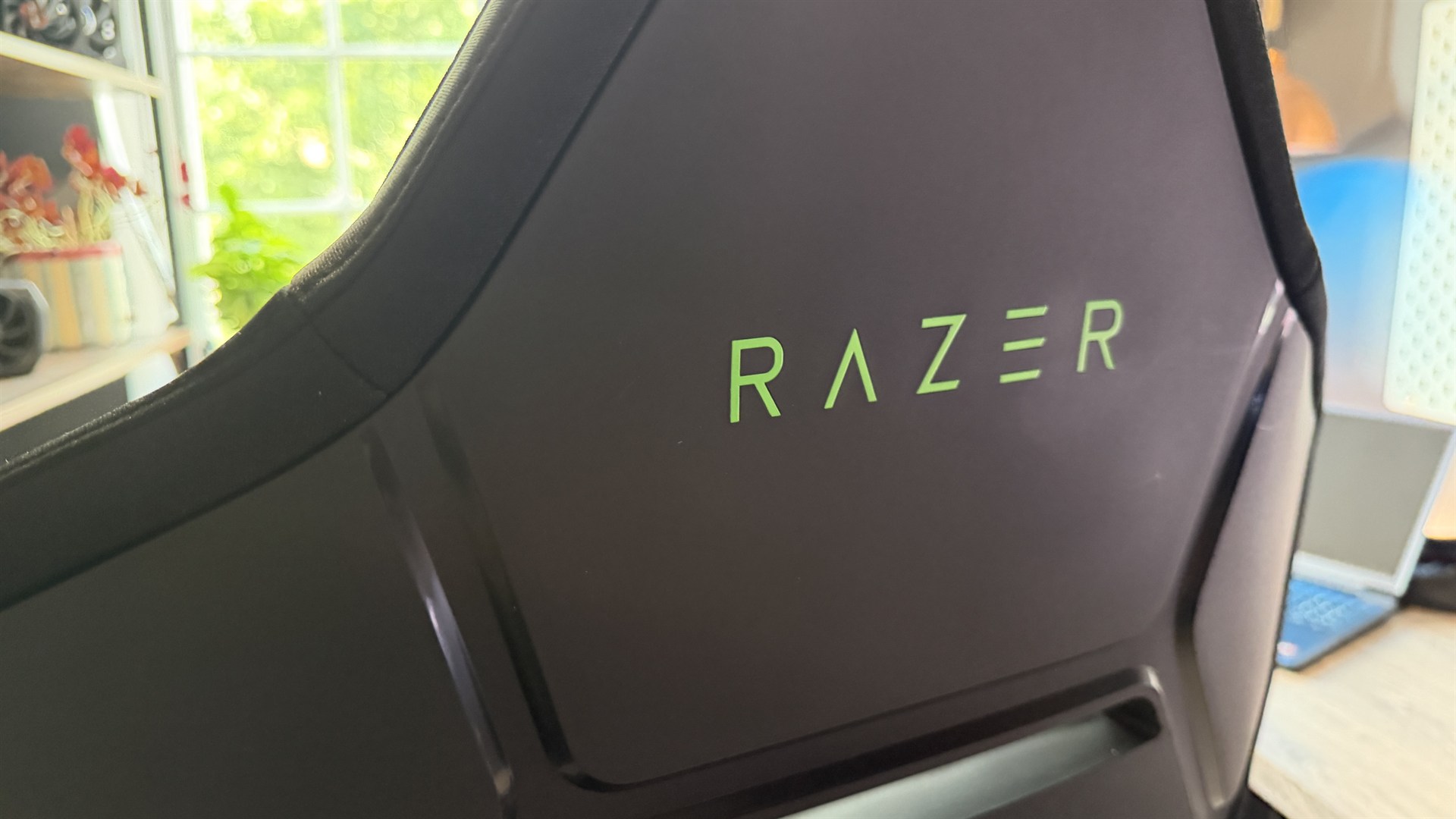 The Razer Soma Chroma gaming chair set up in front of a desk.