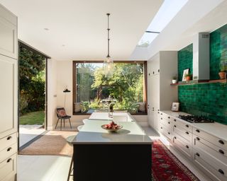 kitchen extension with island and view to garden through picture window