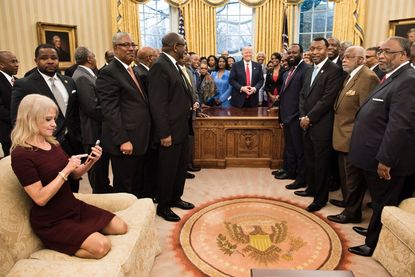 Kellyanne Conway sits on the Oval Office couch