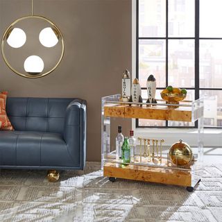 blue leather sofa with bar cart in living room