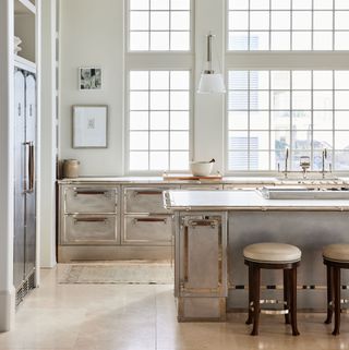 a kitchen with silver metal-working on the cabinets