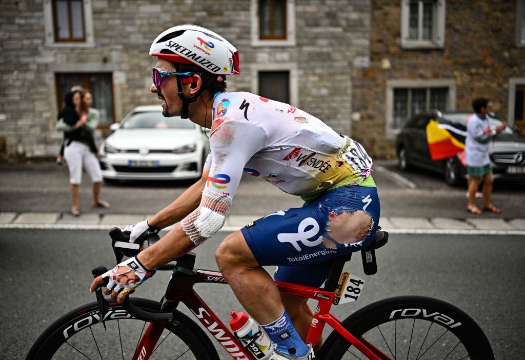 Totalenergies teams French rider Mathieu Burgaudeau cycles in torn attire after suffering a fall during the 6th stage of the 109th edition of the Tour de France cycling race 2199 km between Binche in Belgium and Longwy in northern France on July 7 2022 Photo by Marco BERTORELLO AFP Photo by MARCO BERTORELLOAFP via Getty Images