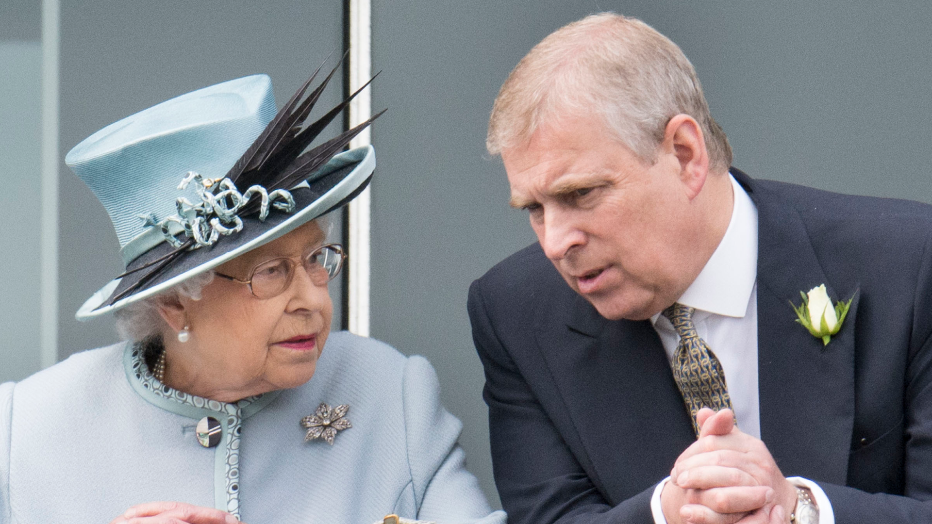 Queen Elizabeth in a pale blue suit talking to Prince Andrew