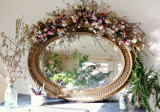 Dried flowers over a mirror