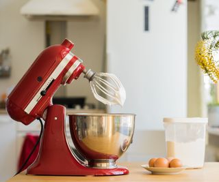A red stand mixer on a countertop