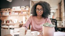 A woman works at her desk in an office.