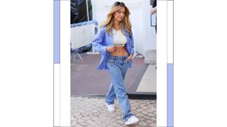 Sydney Sweeney seen wearing blue jeans, a white crop top and a blue and white striped shirt/ at Hotel Martinez during the 76th Cannes film festival on May 22, 2023 in Cannes, France.