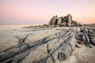 A giant rock island sits in the salt pans of Makgadikgadi, Botswana.