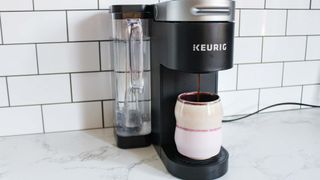 Keurig K-Supreme Coffee Maker pouring cofee into a large mug