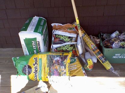Garden Supplies Including Soil Shovel And Plastic Bottles