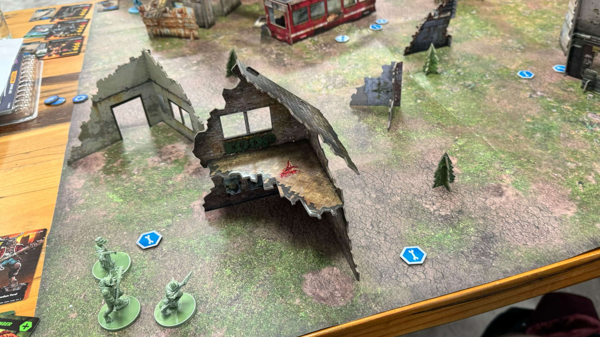 The board of Mutant Year Zero: Zone Wars at the beginning of a match, with terrain and models set up