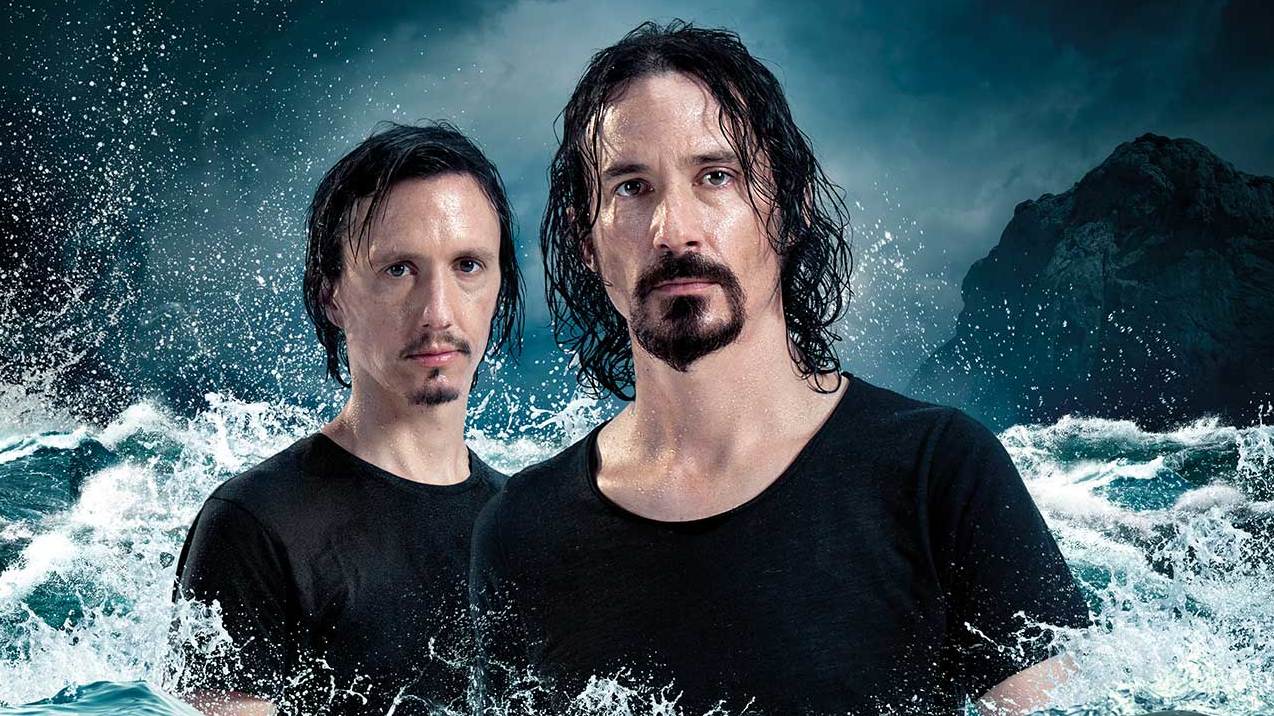 Mario and Joe Duplantier from Gojira standing in the ocean