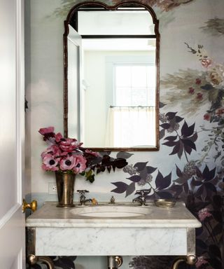 powder room with mural wallpaper, brass mirror and marble basin