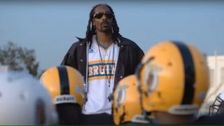 Snoop Dogg talking to youth football players in The Underdoggs
