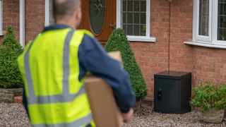 Delivery driver approaching with Yale Smart Delivery Box