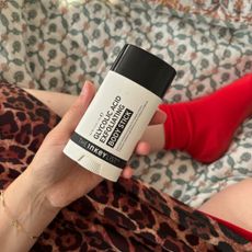 Mica Ricketts holding The Inkey List Glycolic Acid Exfoliating Body Stick