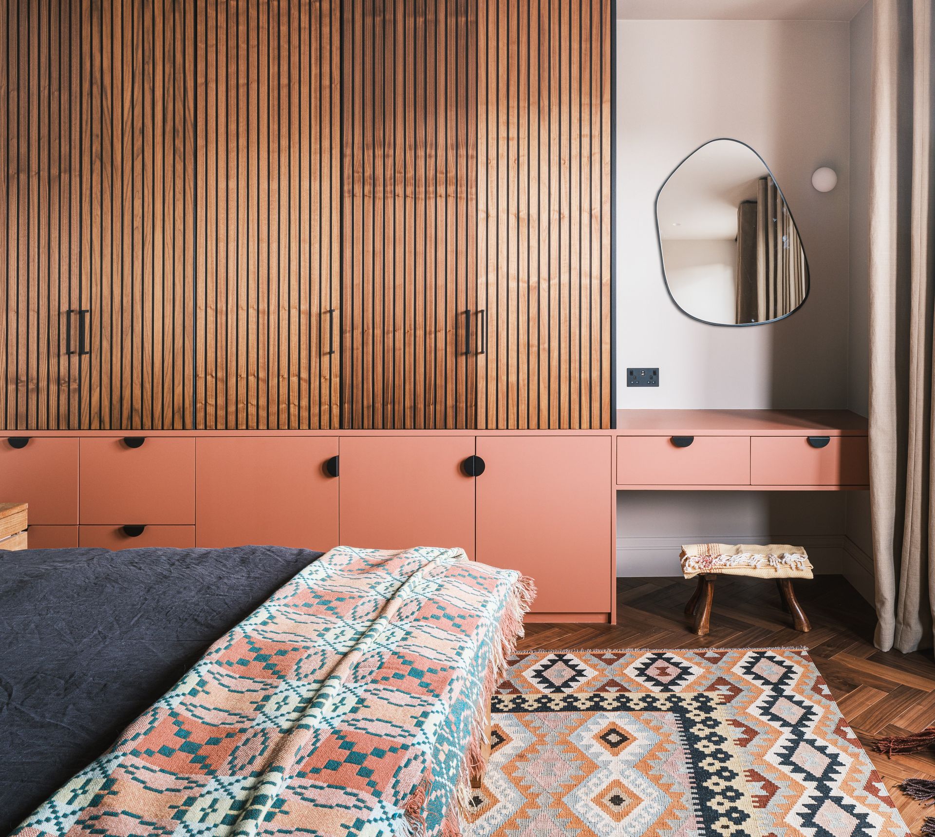 A small bedroom with clever fitted wardrobe design