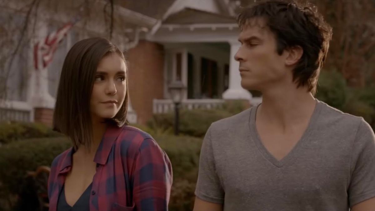 Nina Dobrev and Ian Somerhalder holding hands in The Vampire Diaries.