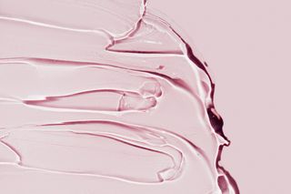 Menopause and sex drive: Closeup strokes of transparent lube spread on bright pink background