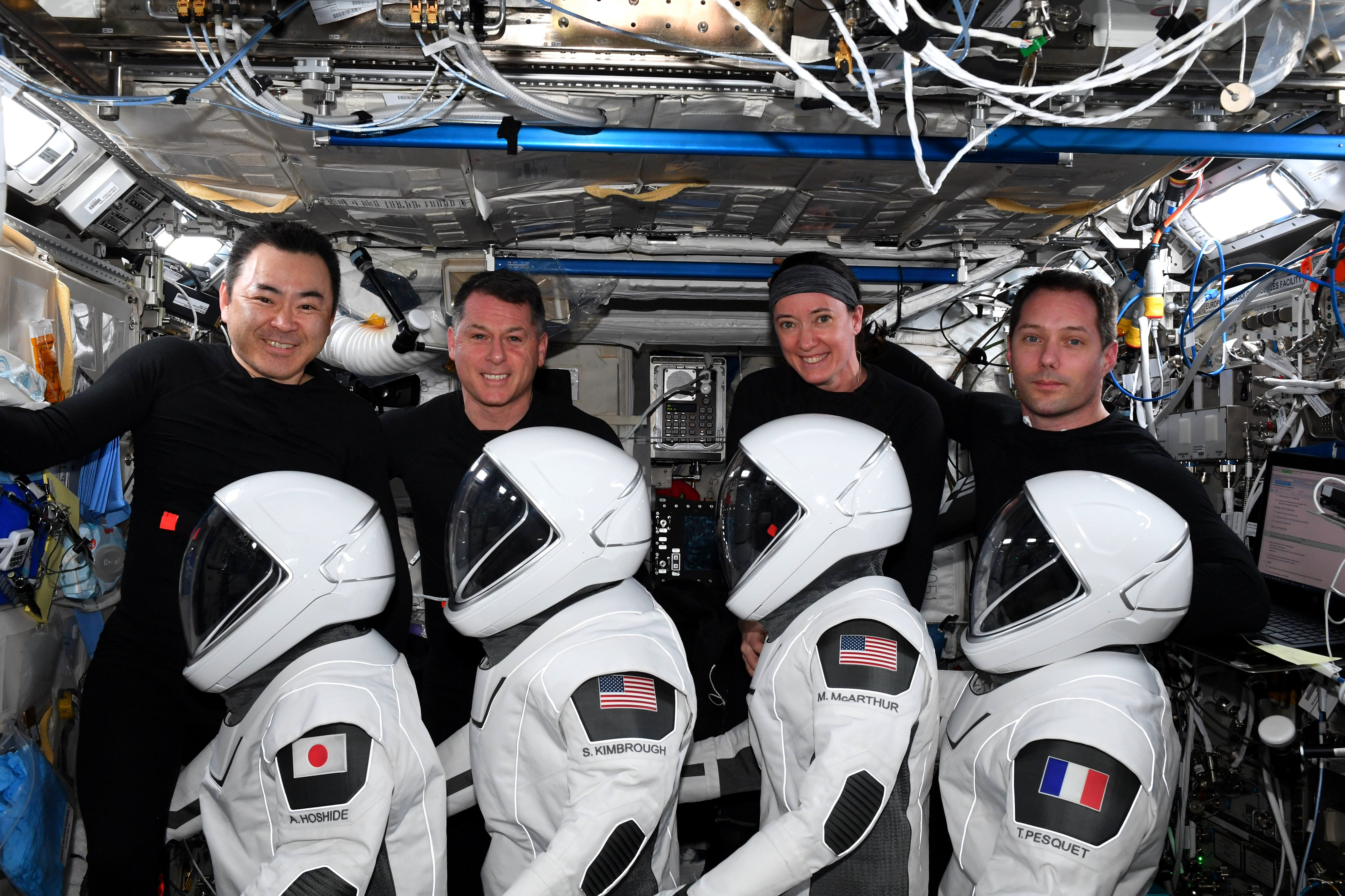 The four astronauts of NASA and SpaceX's Crew-2 mission pose with their launch and entry suits as they wrap up a six-month mission to the International Space Station. They are: (from left) Akihiko Hoshide of the Japan Aerospace Exploration Agency, Shane Kimbrough and Megan McArthur of NASA and Thomas Pesquet of European Space Agency.
