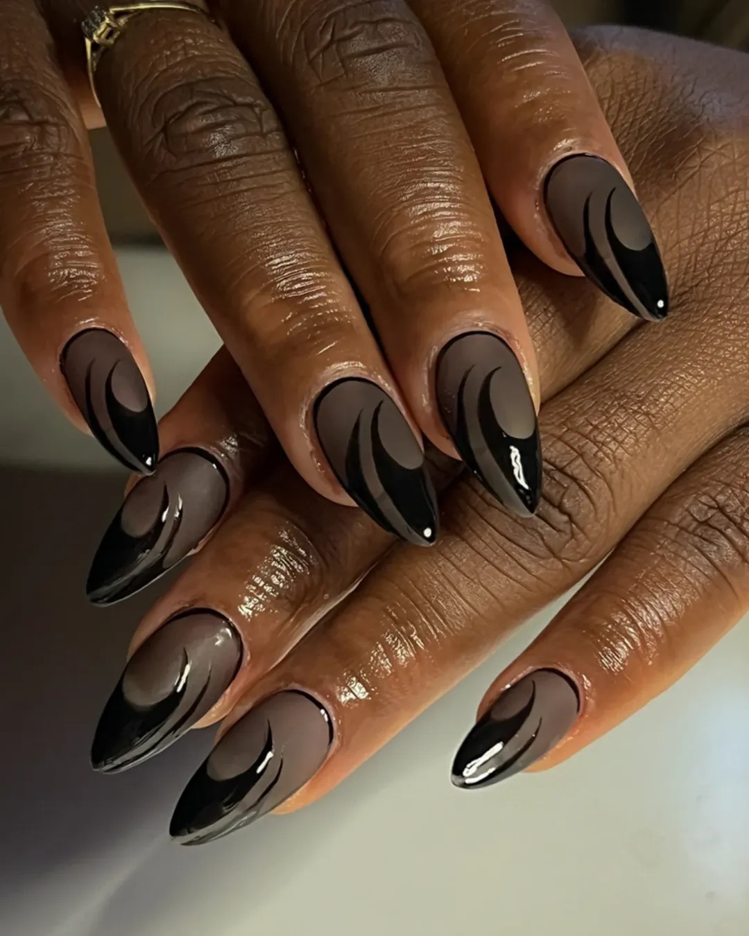 a close up photo of a person wearing a black French manicure with a matte black base color
