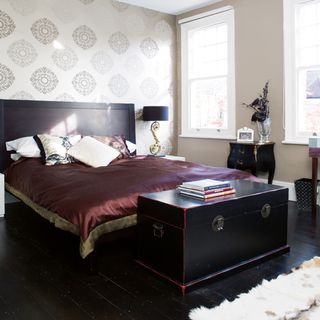 bedroom with dark flooring and bed
