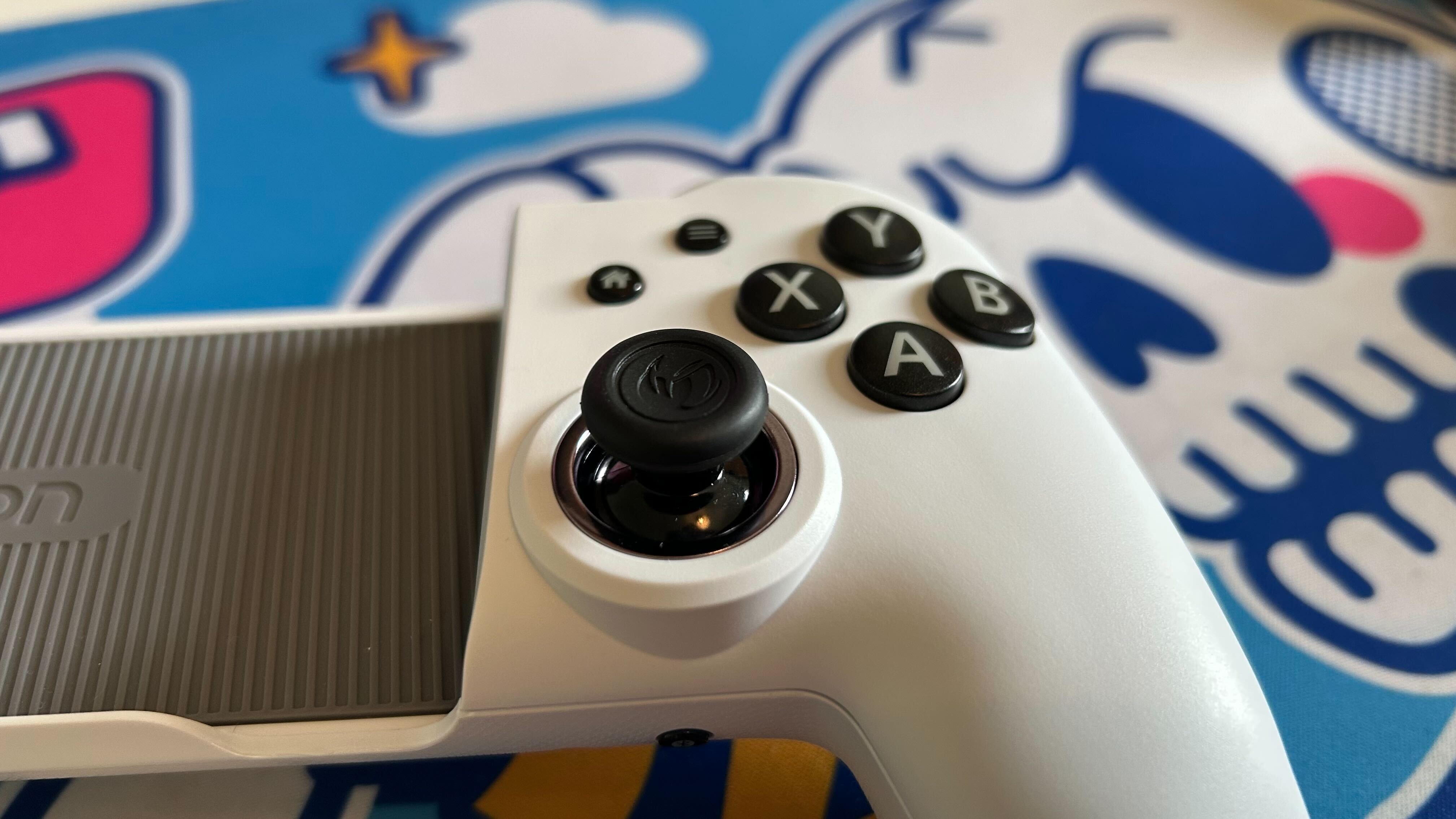 Close-up of thumb on mobile controller MG-X Pro.