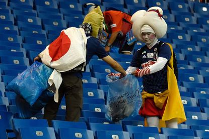 Japan's fans cleaning up after World Cup loss. 
