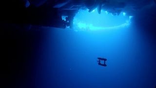 The underwater robot beneath the ice, with the propeller of the ice-breaker Aurora Australis visible. 