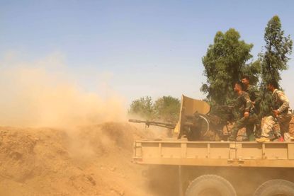 Iraqi Kurdish peshmerga fighters battle ISIS