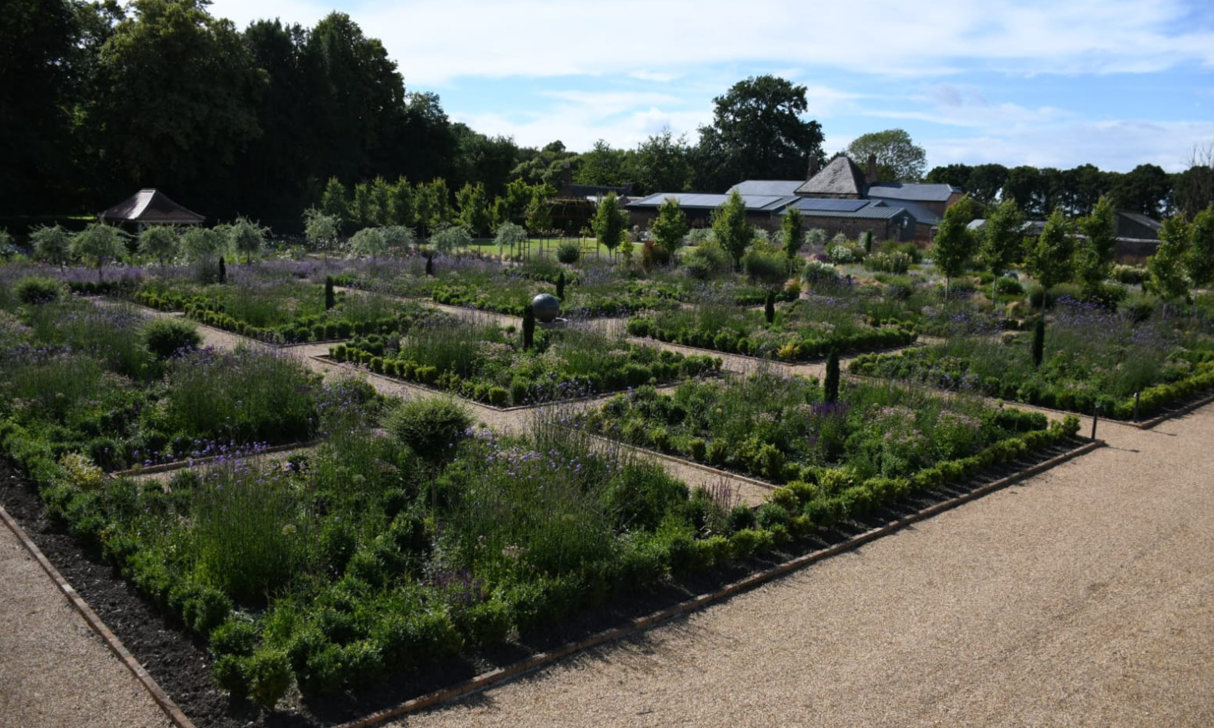 Image from above of walled garden with four distinct areas, the closest showing box borders
