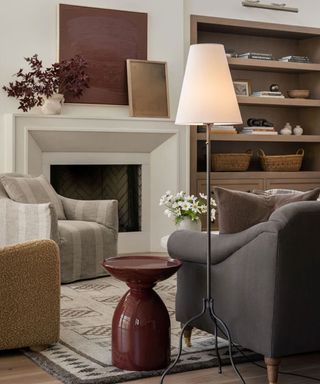 Cozy living room with table lamp, seating and fireplace