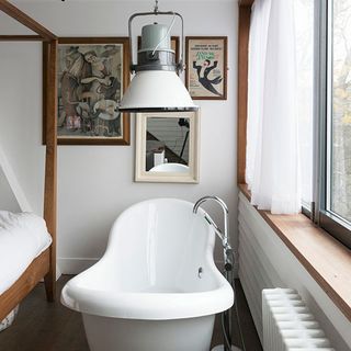 bathroom with white curtain on window and bathtub