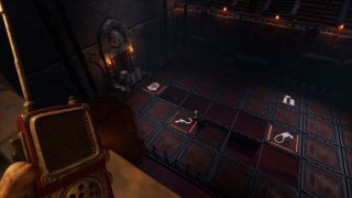 We Were Here Forever - A player holds a walkie talkie while looking at another player below standing on a checkerboard of trap doors with symbols for medieval weapons.