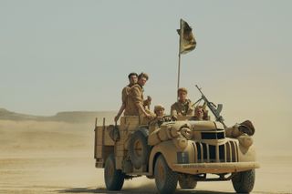 The SAS Rogue Heroes squad riding in a truck out in the desert
