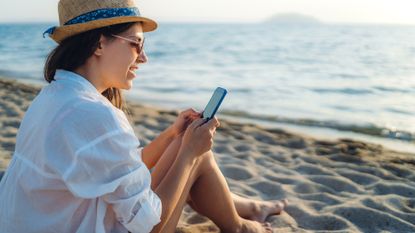 Woman on phone on beach