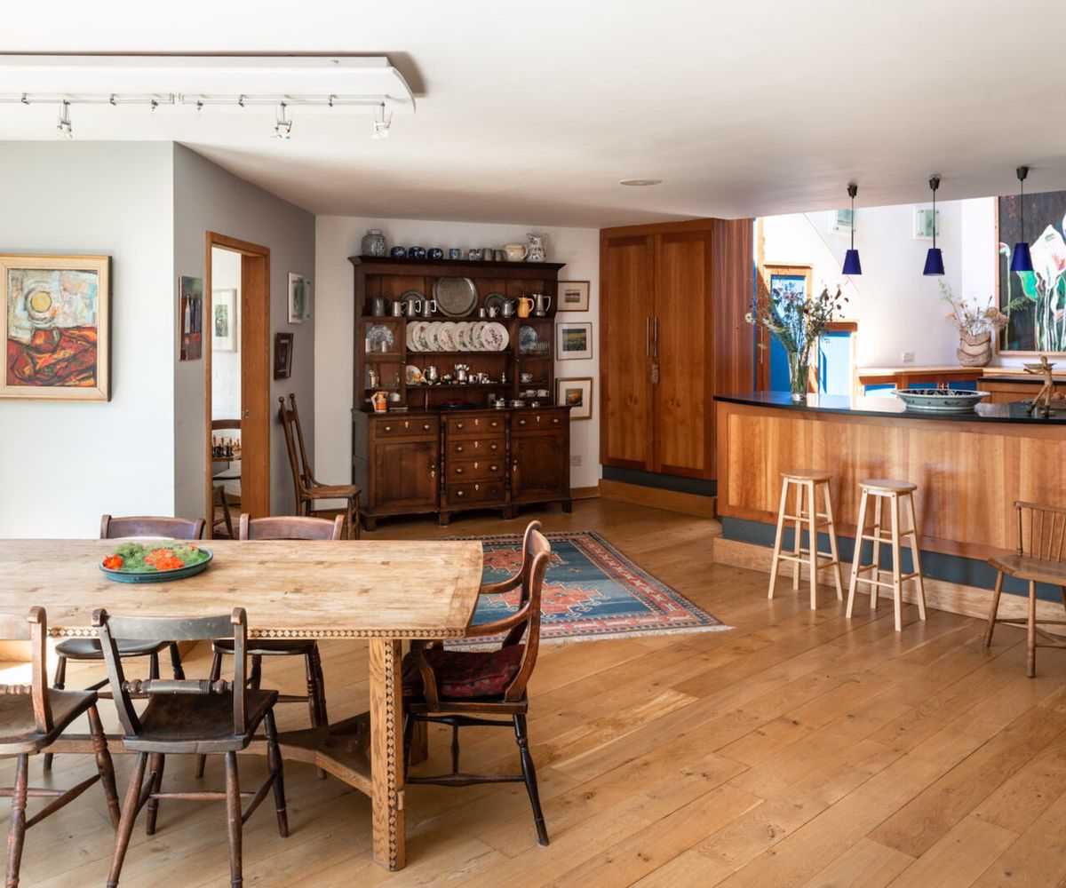 A kitchen with wooden flooring and a kitchen island