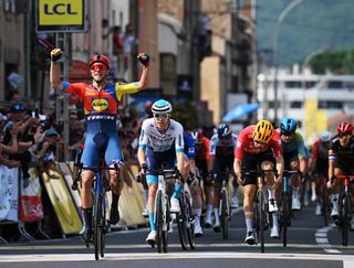 Fred Wright of Bahrain Victorious follows Jonathan Milan of Lidl-Trek across finish line into Issoire