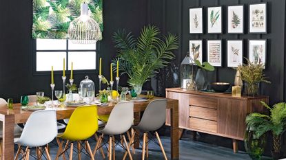 dining area with black wall and wooden dining table 