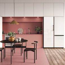 kitchen and dining area with pink wall and round dining table with chairs