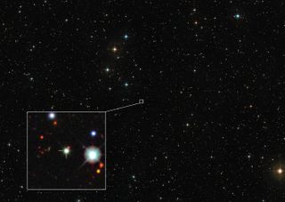 A view of stars in the night sky with a box that highlights the region around the quasar at hand.