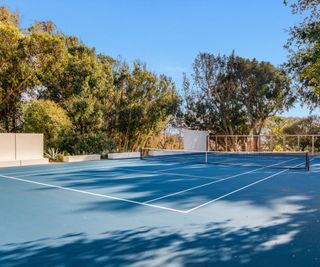 Malibu Mansion tennis courts surrounded by trees