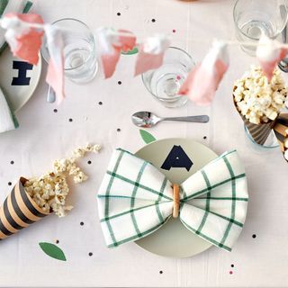 pop corn on table with spoon and glass